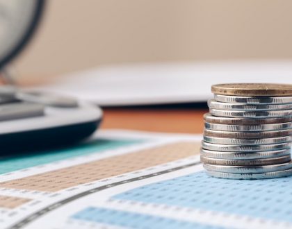 Stack of coins on top of a balance sheet