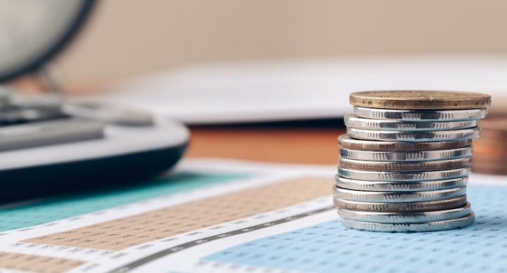 Stack of coins on top of a balance sheet